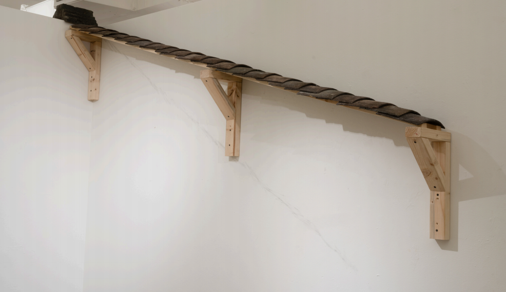 Xingzheng Bao, Migrating Eaves, 2025, lumber, screws, and roof tiles