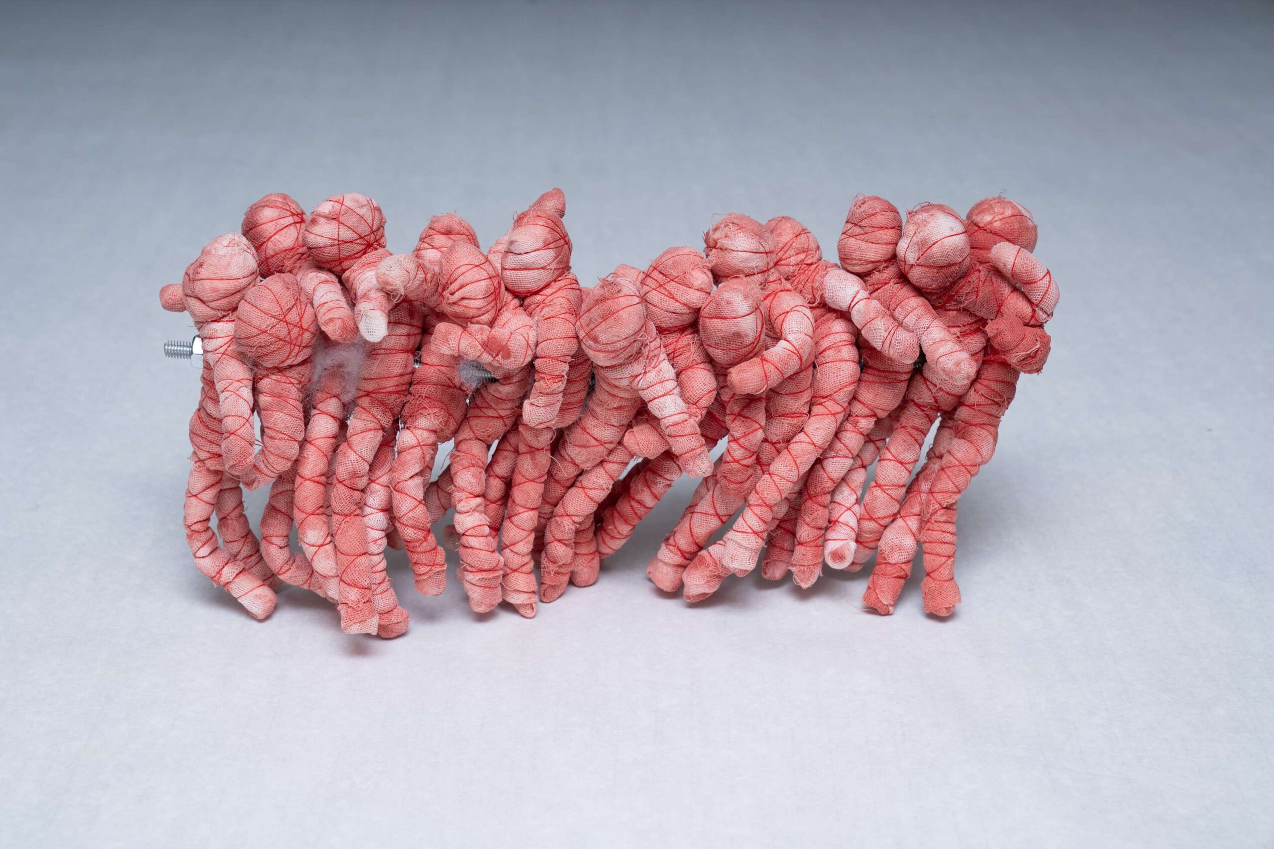 Yanzi Zhang, We, 2023, gauze, screws, mineral pigments, thread, and puppets